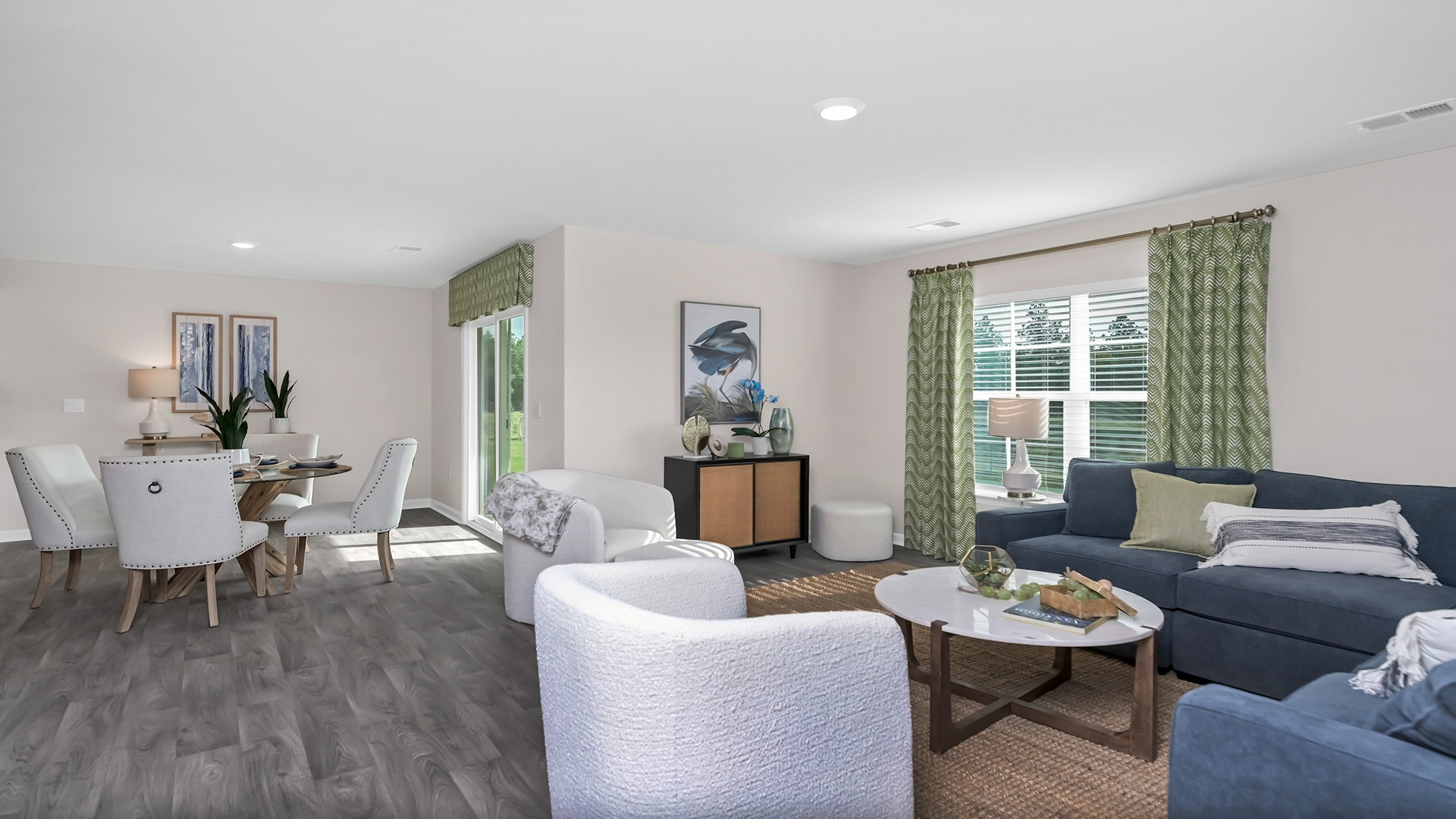 Open concept dining and living areas with vinyl flooring