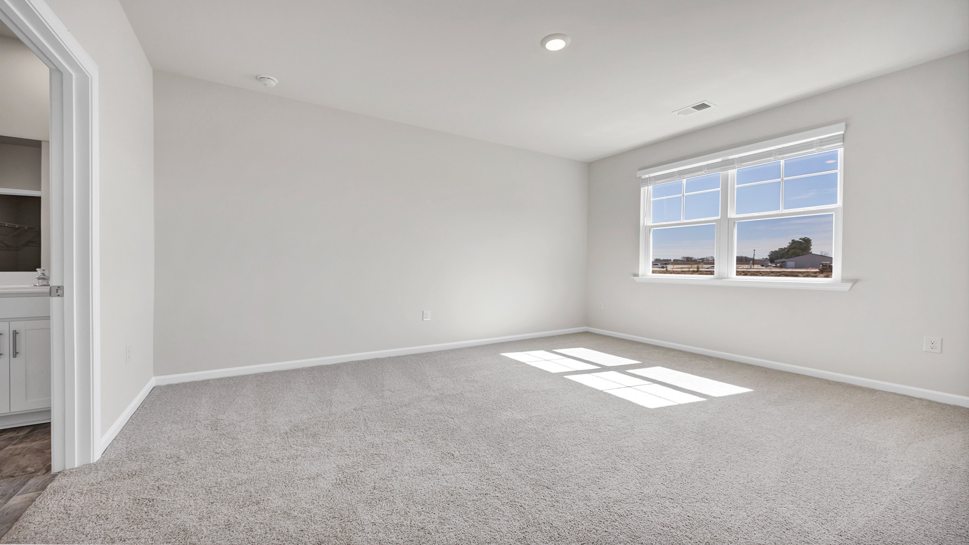 Private primary suite at the back of the one-story home for sale in Gates Village