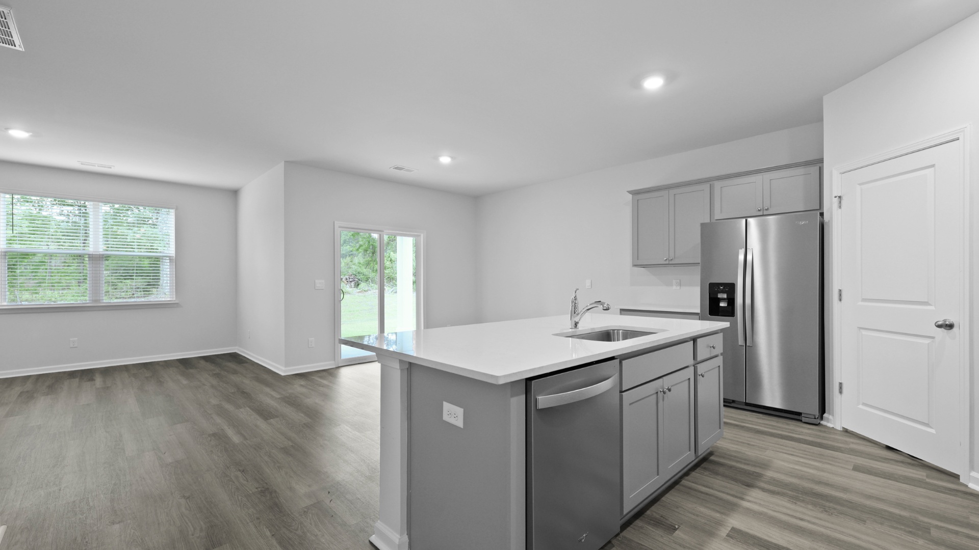 Floating kitchen island overlooks the dining and living areas