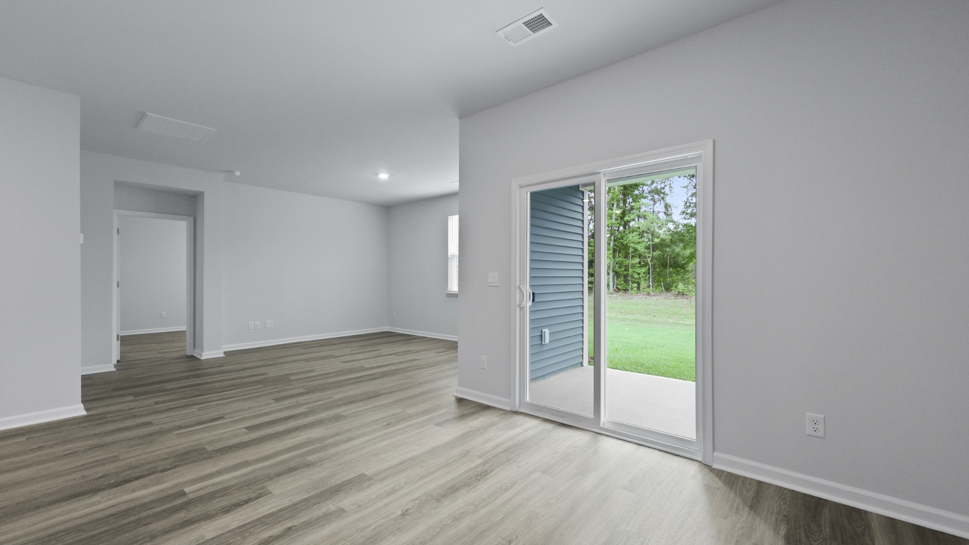 Access to the back patio from glass sliding doors in the dining area