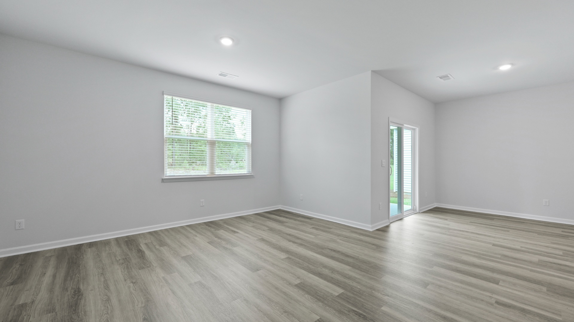 Dining and living areas in new construction home in Lugoff, SC with an open-concept design and modern features