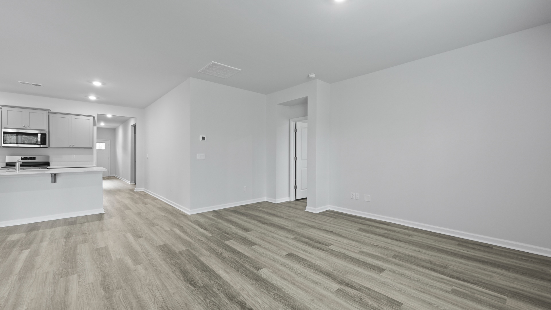 Access to the primary suite at the back of the home off the living area