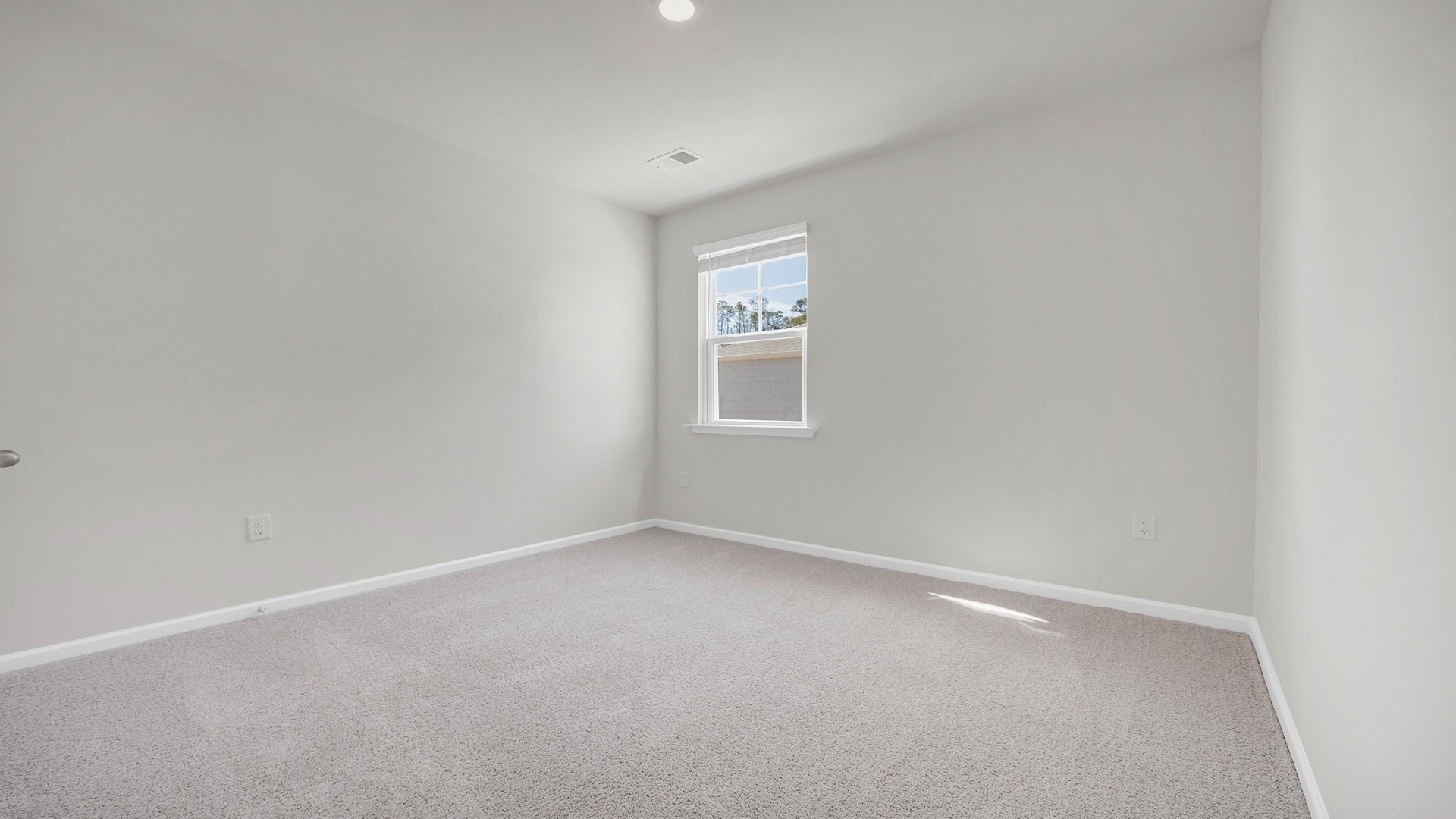 Bedroom 3 in new construction home with a window for light and carpet floors