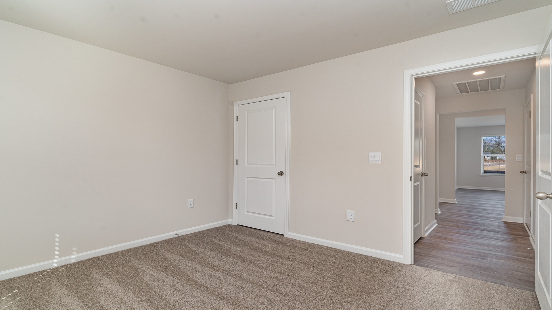 Bedroom 3 with a window and carpet flooring