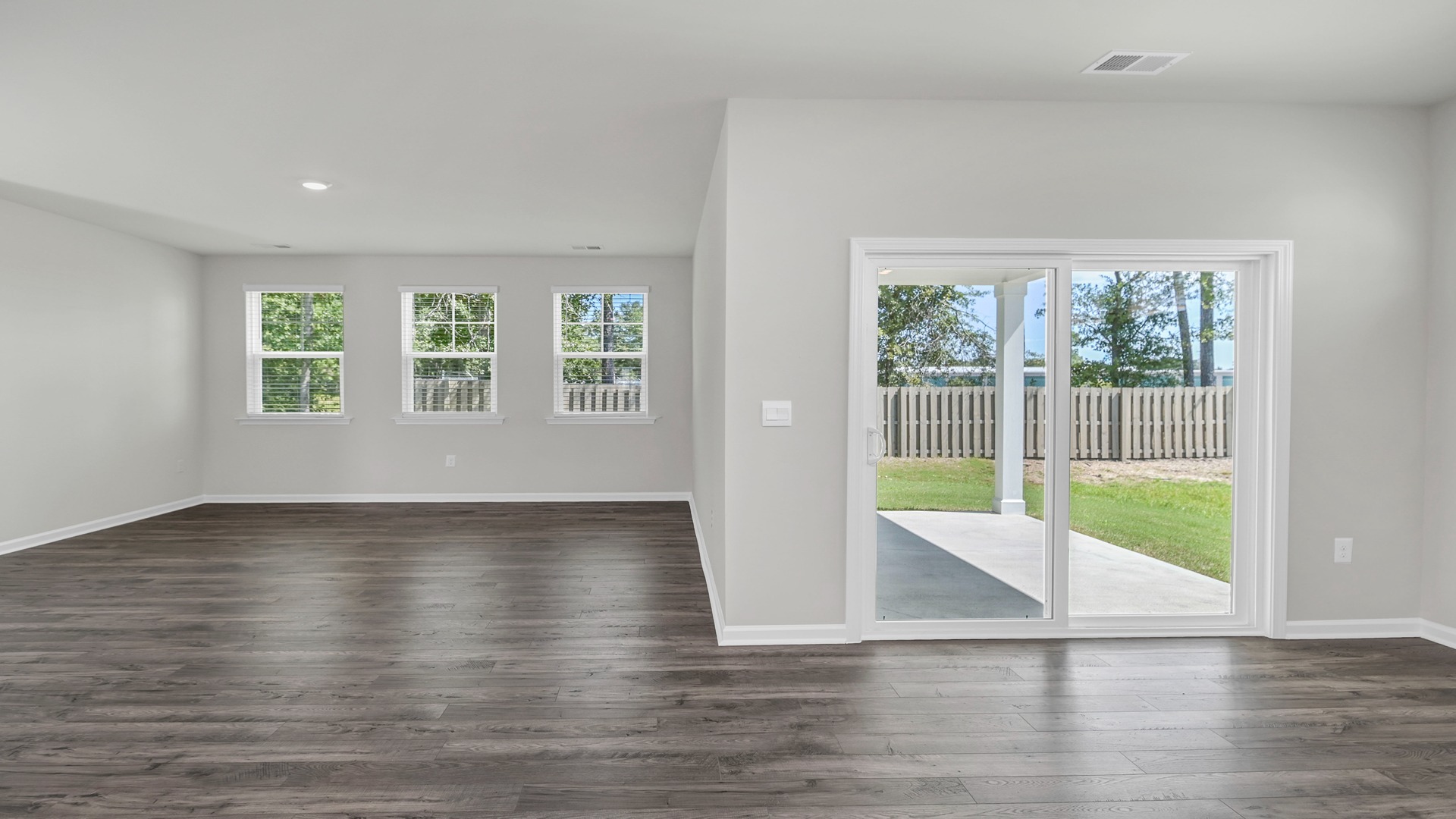 Open concept dining and living area with matching vinyl floors