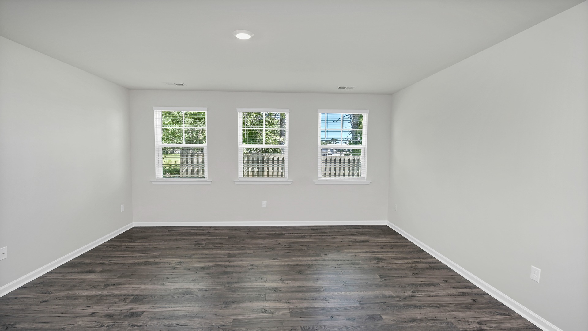 Large living area with vinyl floor in home for sale in Lugoff, SC