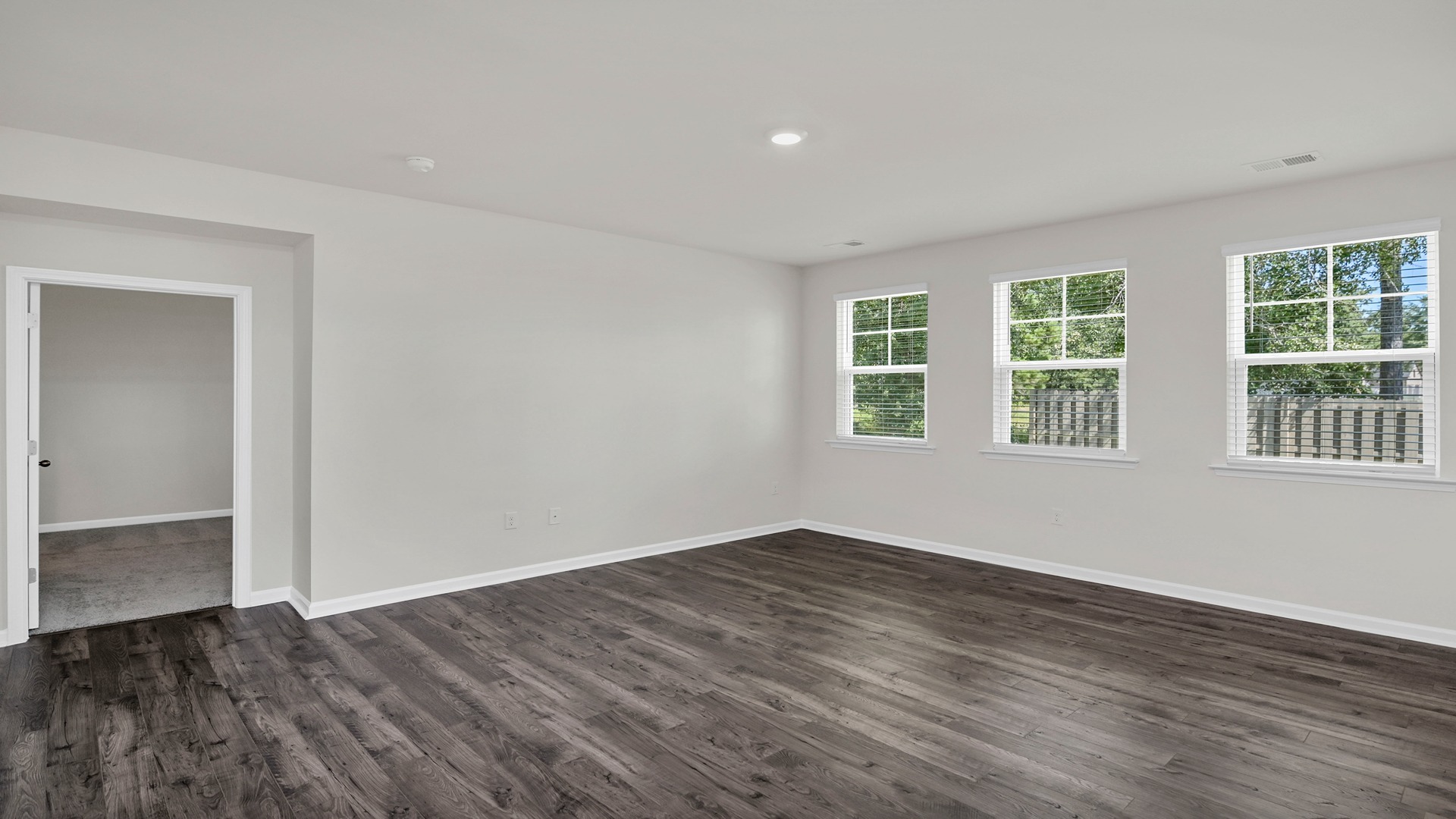 Living area leads into the primary suite at the back of the home