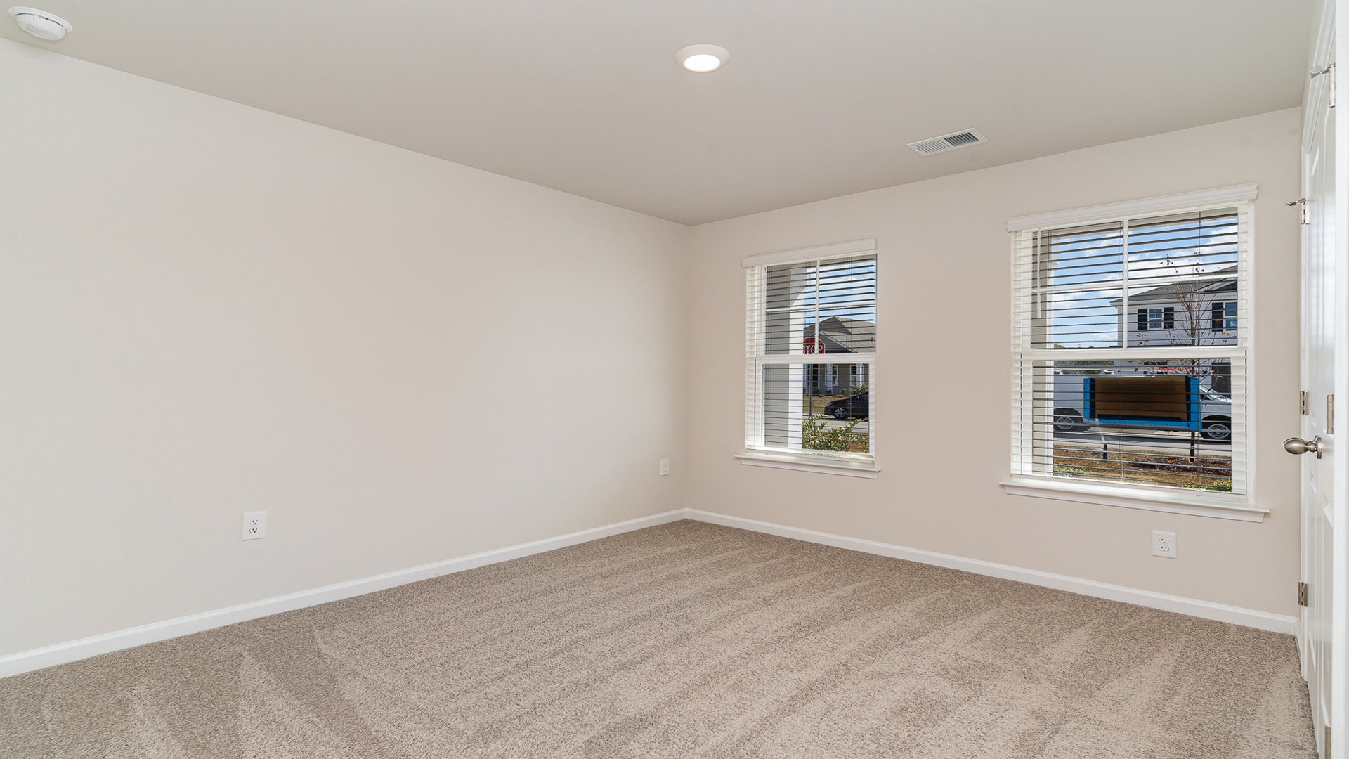 Bedroom 2 with window and carpet flooring