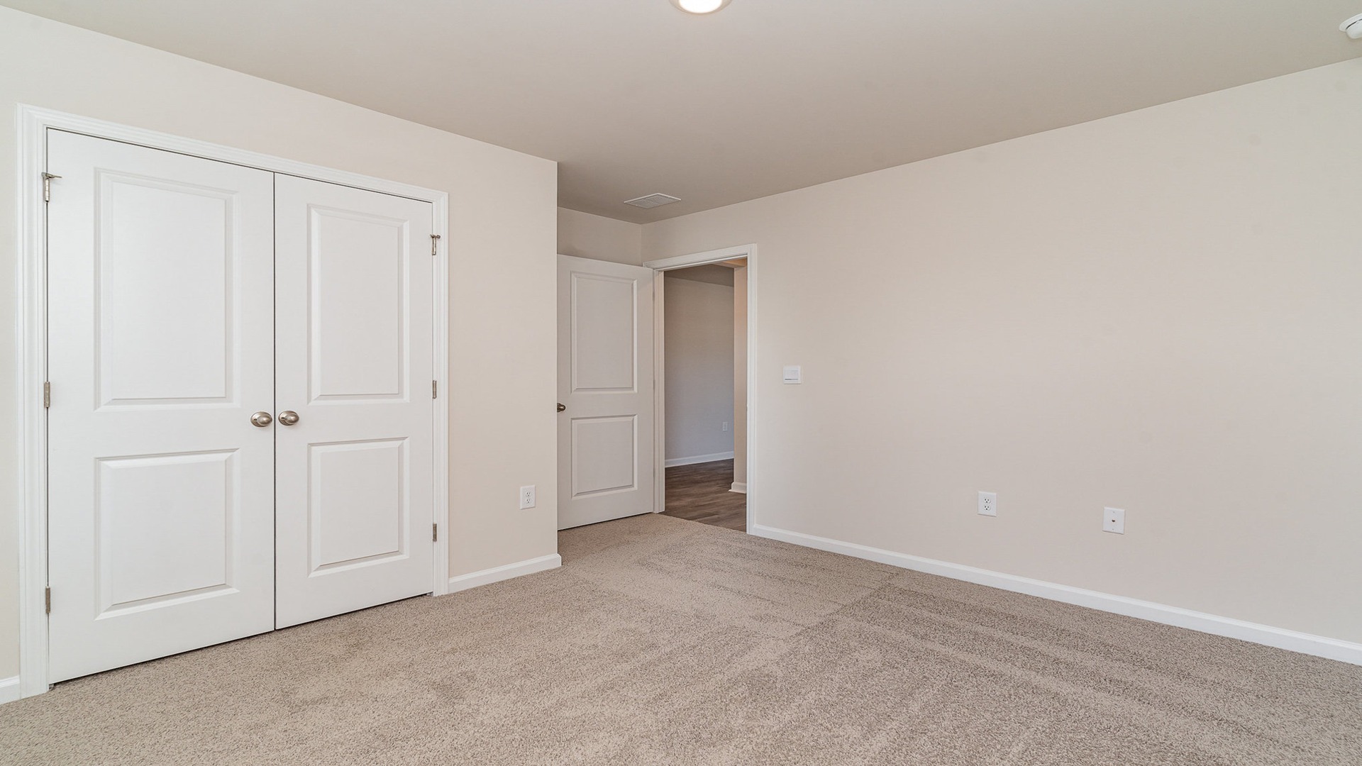 Bedroom 2 with window and carpet flooring