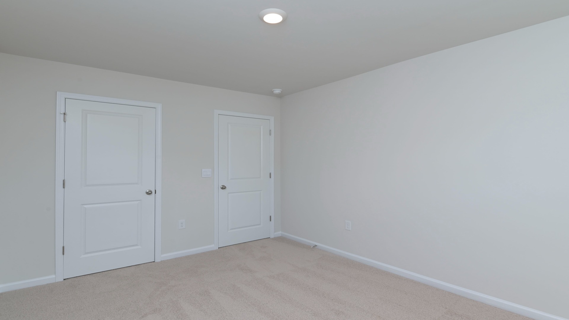 Bedroom 2 with window and carpet flooring