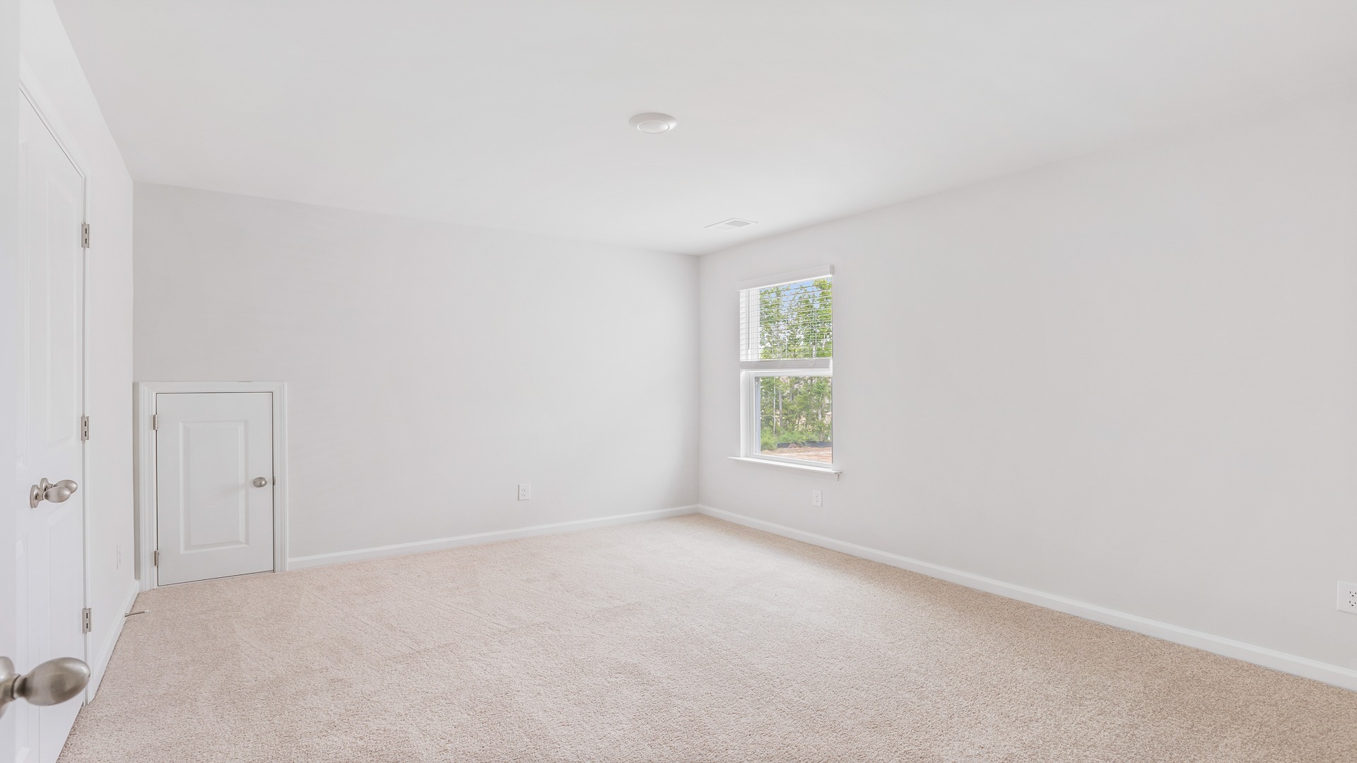 Bedroom 2 upstairs with carpet flooring and a window