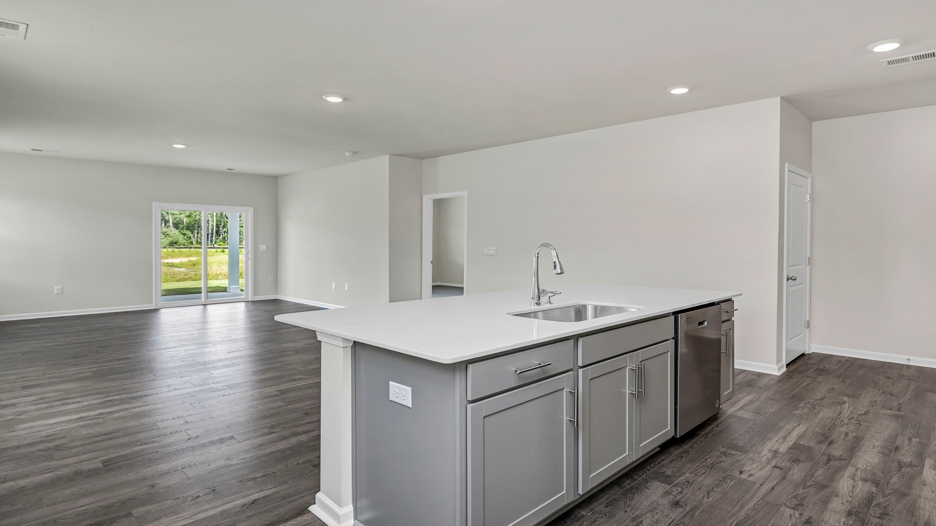 Floating kitchen island overlooks dining and living areas
