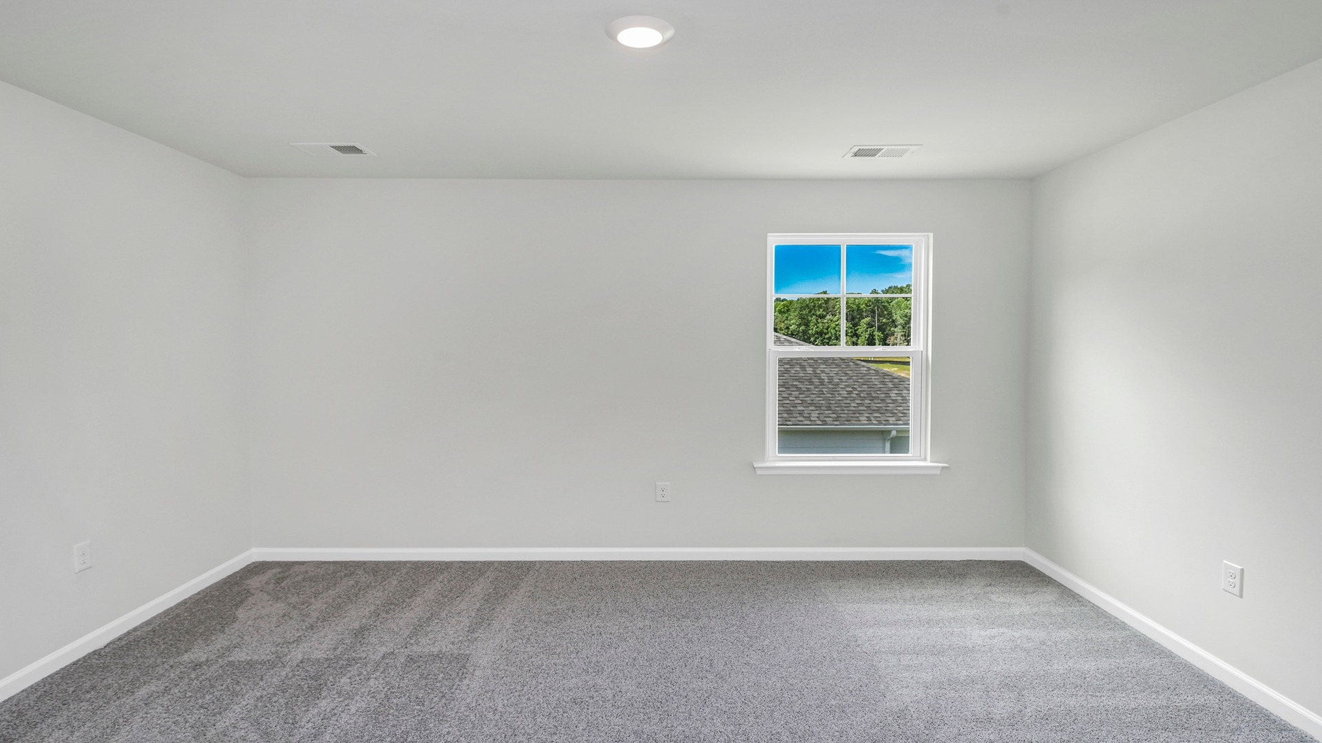 Bedroom 2 upstairs with carpet flooring and a window for light