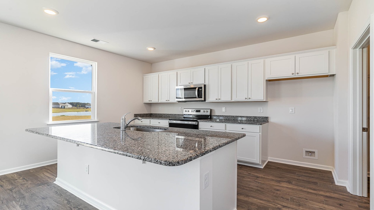 There is a floating kitchen island with room for barstool seating.