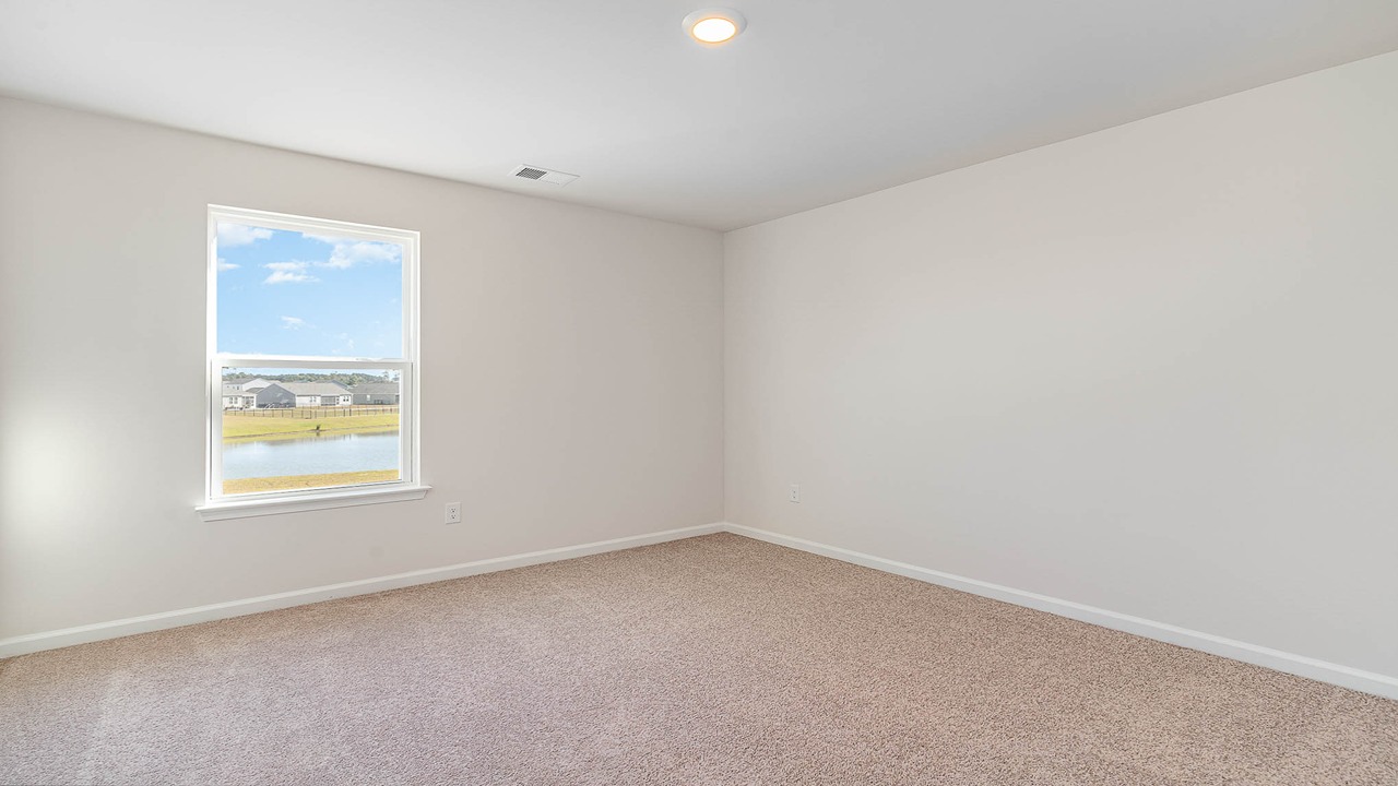 Photos of additional upstairs bedrooms that feature carpet flooring and windows for natural light.
