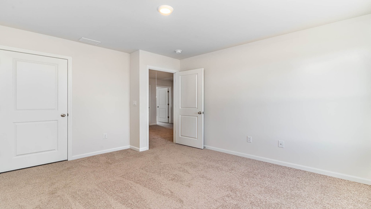 Photos of additional upstairs bedrooms that feature carpet flooring and windows for natural light.