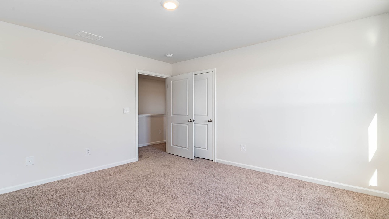 Photos of additional upstairs bedrooms that feature carpet flooring and windows for natural light.