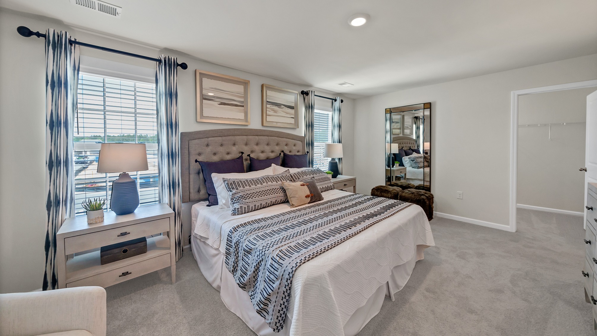 Ample natural light in primary bedroom from 2 windows