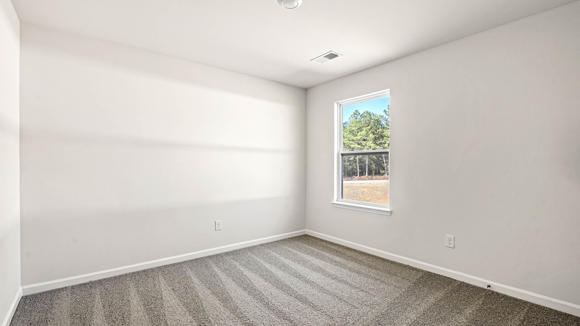 Bedroom 4 upstairs with carpet flooring and a window
