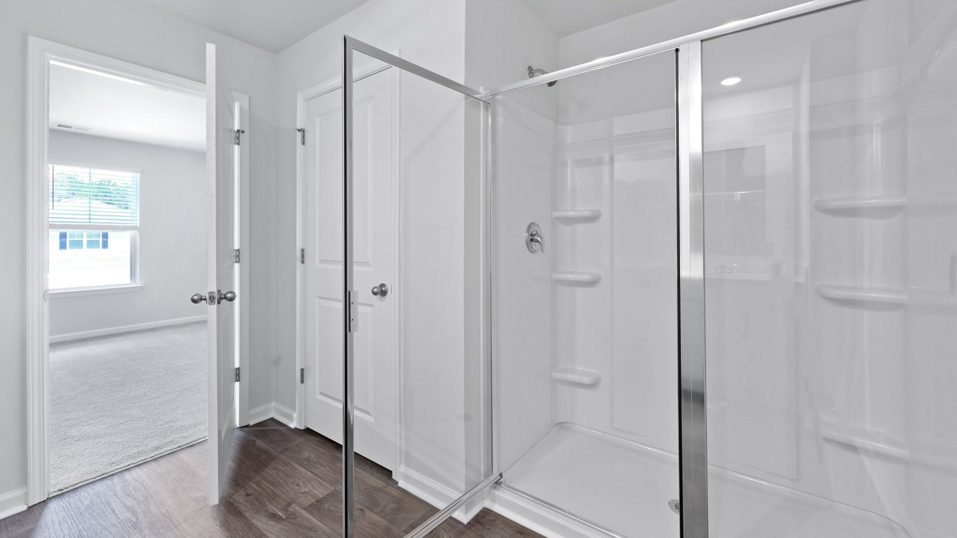 Primary standup shower with glass doors