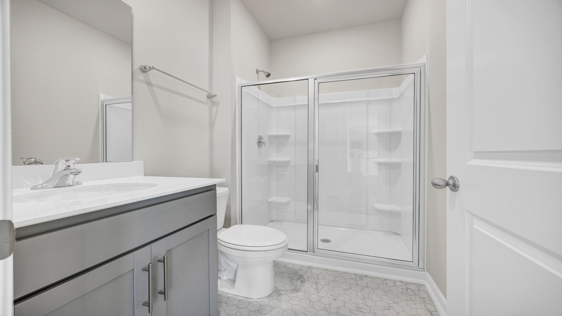Full bathroom downstairs in home for sale across the hall from downstairs bedroom