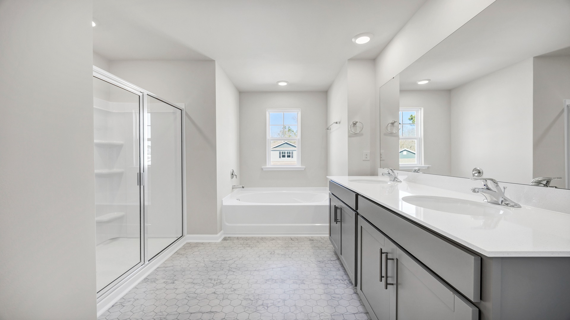 En-suite primary bathroom with a garden tub and walk-in primary shower