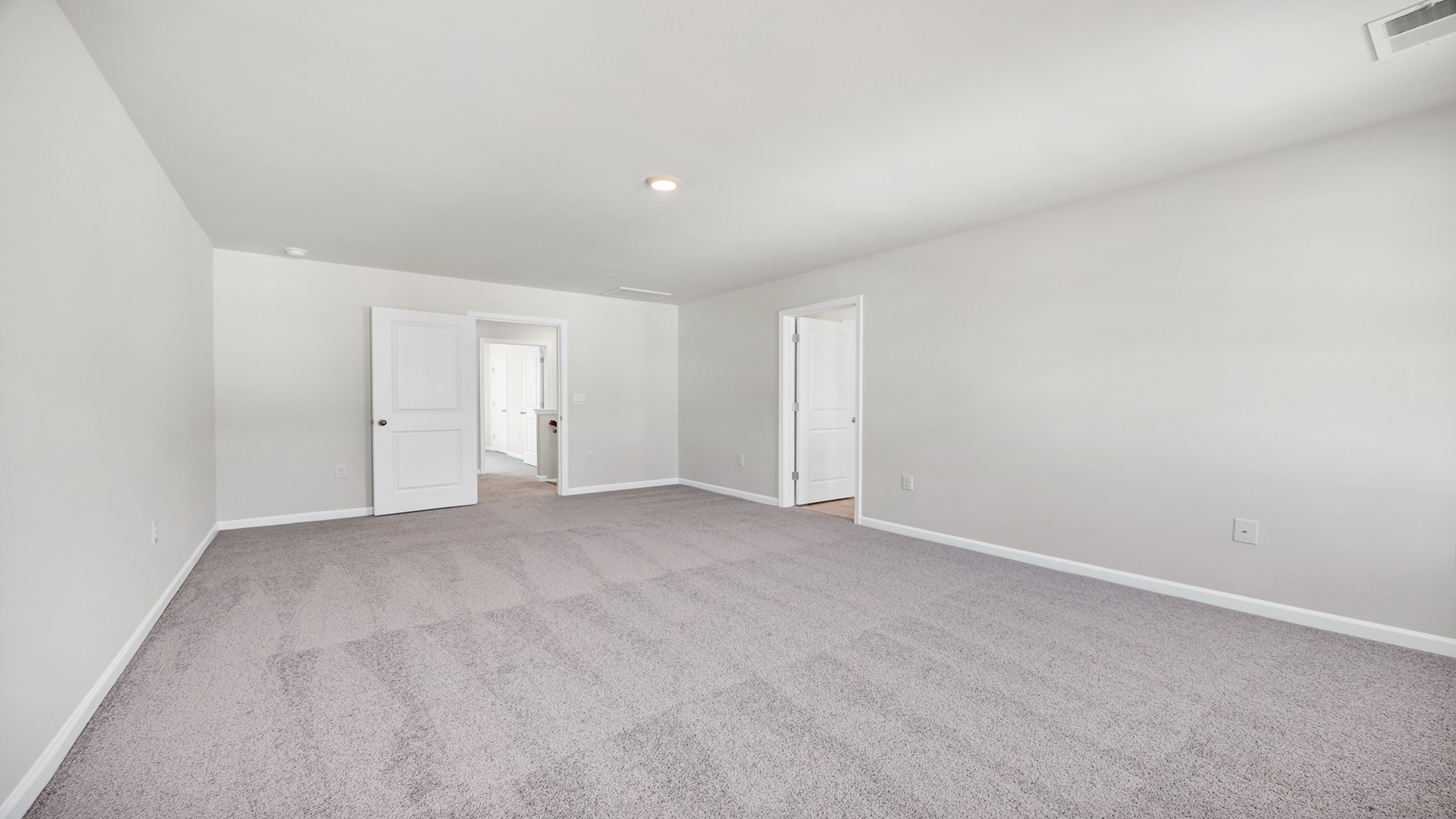 Plush carpet floors and neutral walls in upstairs primary bedroom in the Hayden floorplan in Lugoff