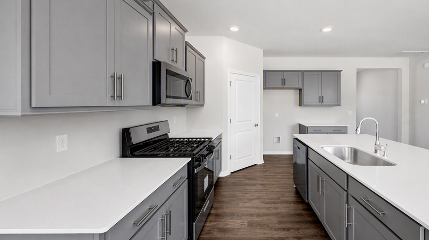 White quartz counter tops and new stainless-steel appliances in the kitchen