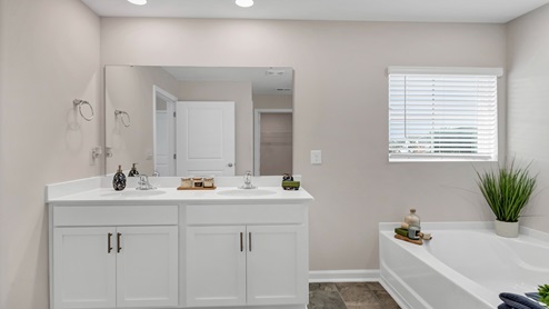 Cali Primary Bathroom with white cabinets