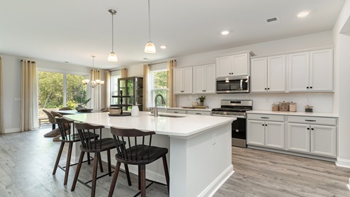 The Harbor Oak kitchen features a floating kitchen island with room for barstool seating.