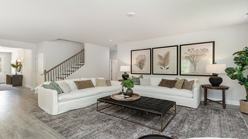 Back downstairs, the living room greets you from the bottom of the stairway.