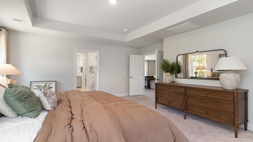 The Harbor Oak primary bedroom is spacious and features an additional seating area.