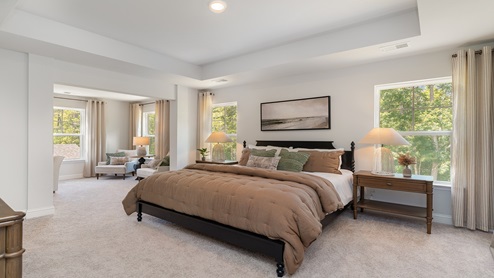 The Harbor Oak primary bedroom is spacious and features an additional seating area.