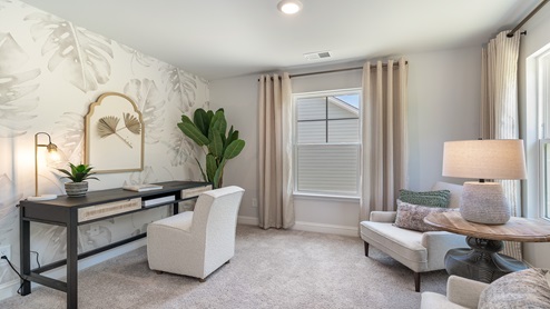 The Primary Bedroom features an additional seating area.