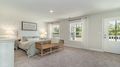 Bedroom 3 features several windows, plus access to the second-floor balcony.