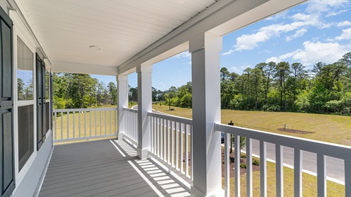 The second-floor balcony/porch overlooks the front of the home.