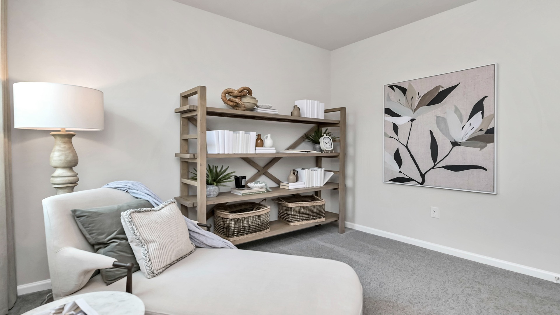 This bedroom is carpeted and staged as a home office/sitting area.