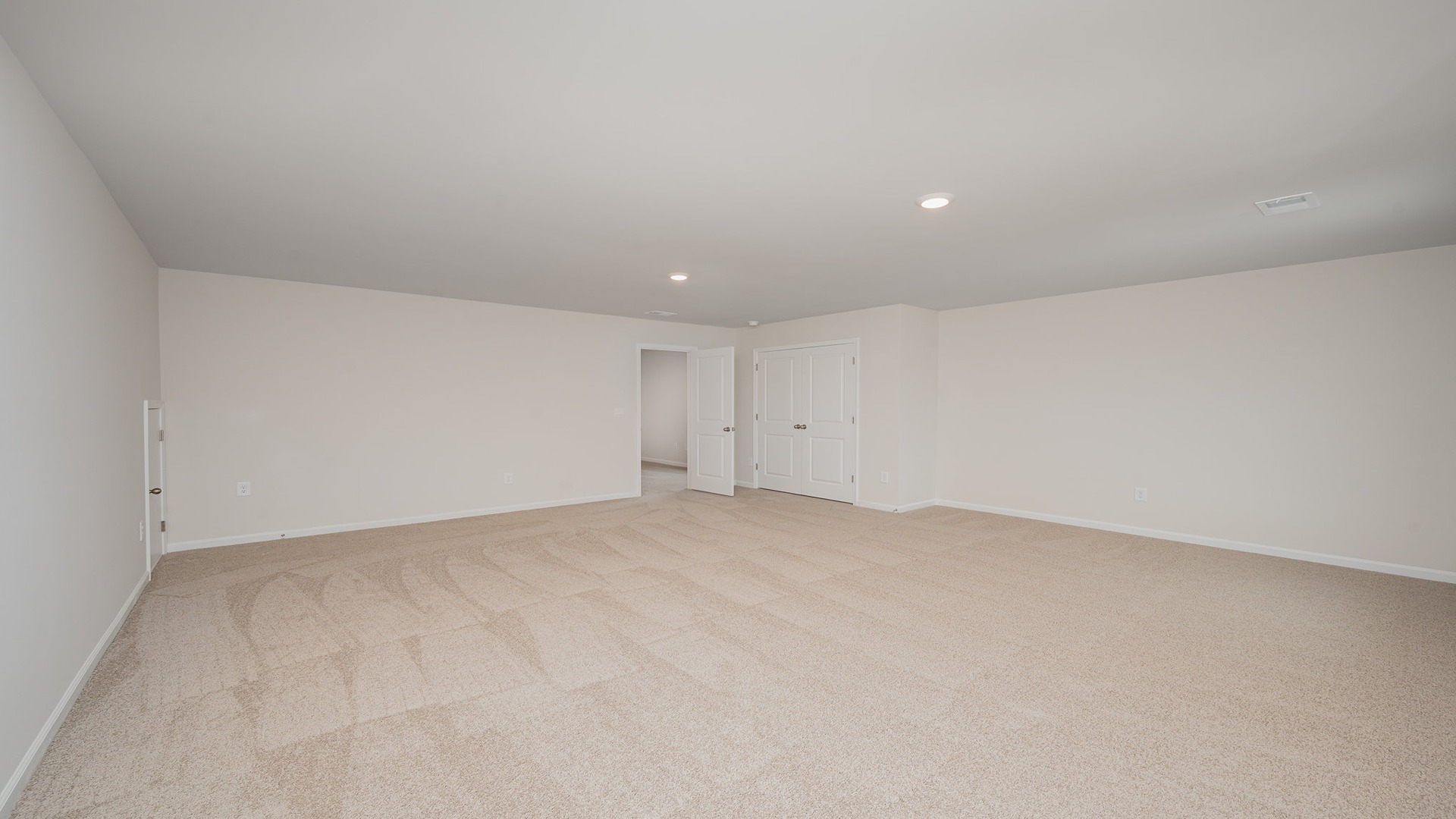 Upstairs bonus room with several windows.