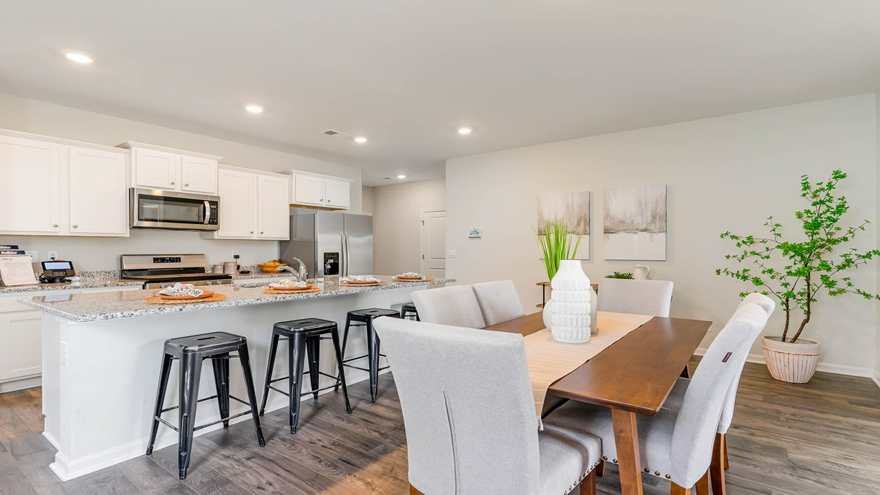 The kitchen and dining areas are open concept finished with luxurious Revwood flooring.