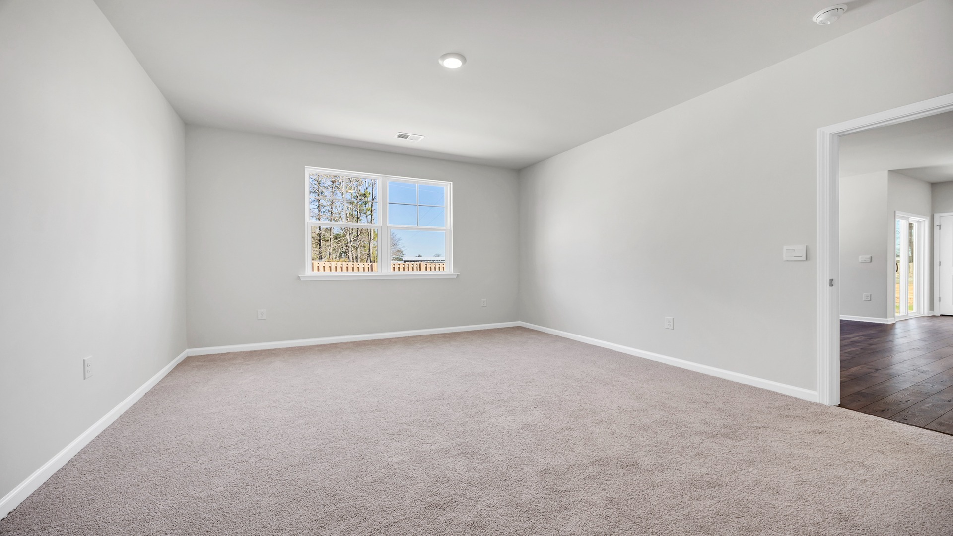 Private primary suite tucked into back of the home