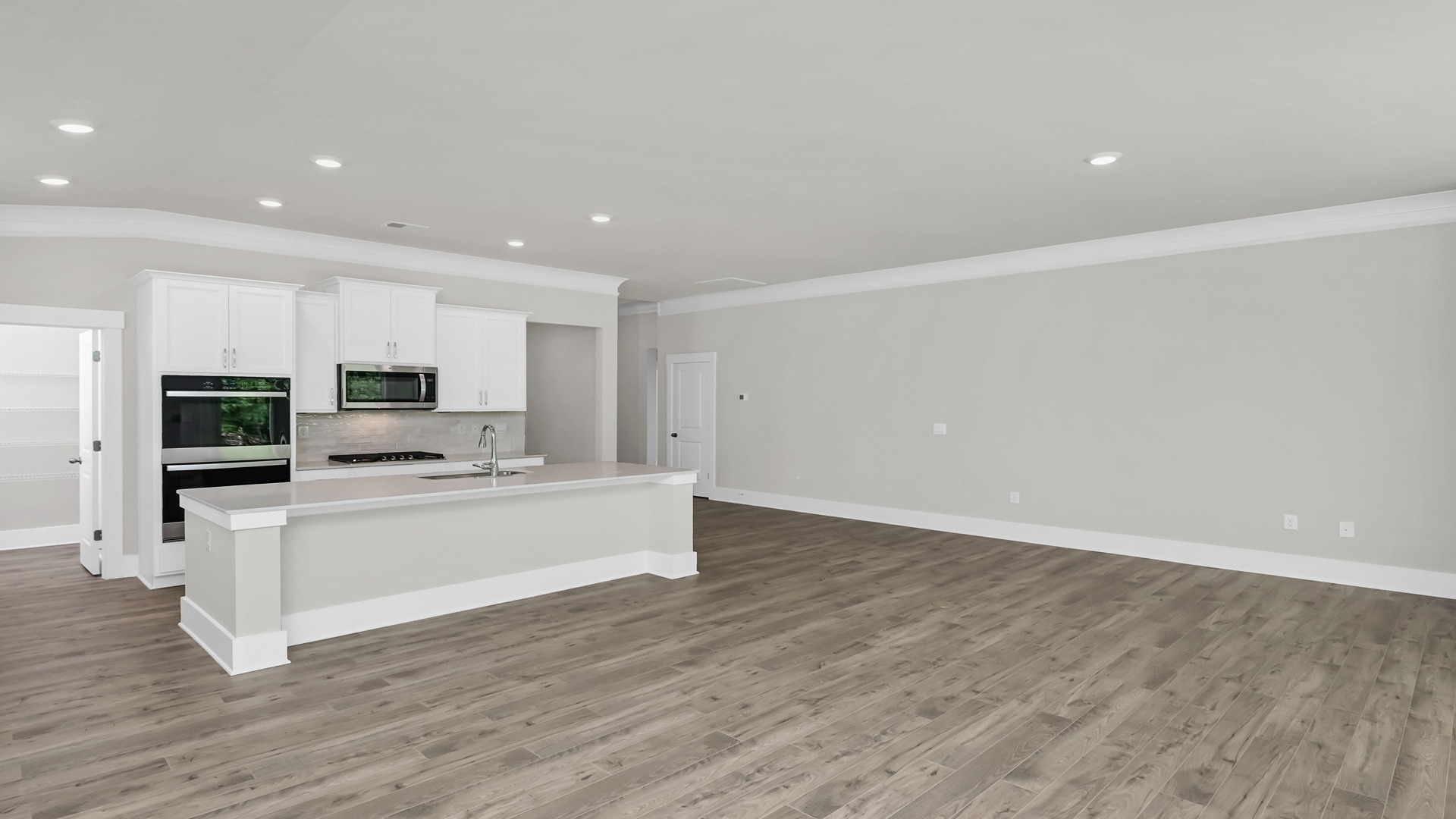 The living room is spacious with a window for natural light.