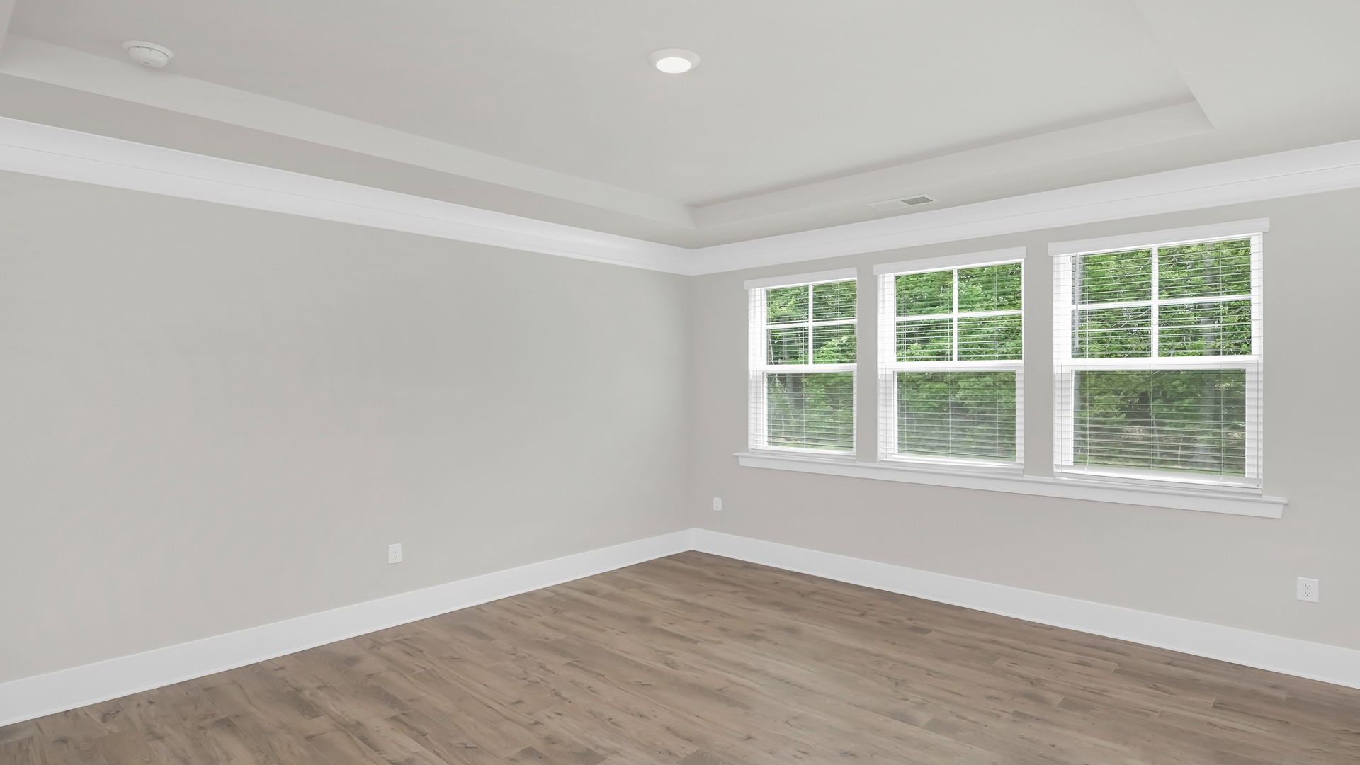 The Primary bedroom with Revwood flooring.