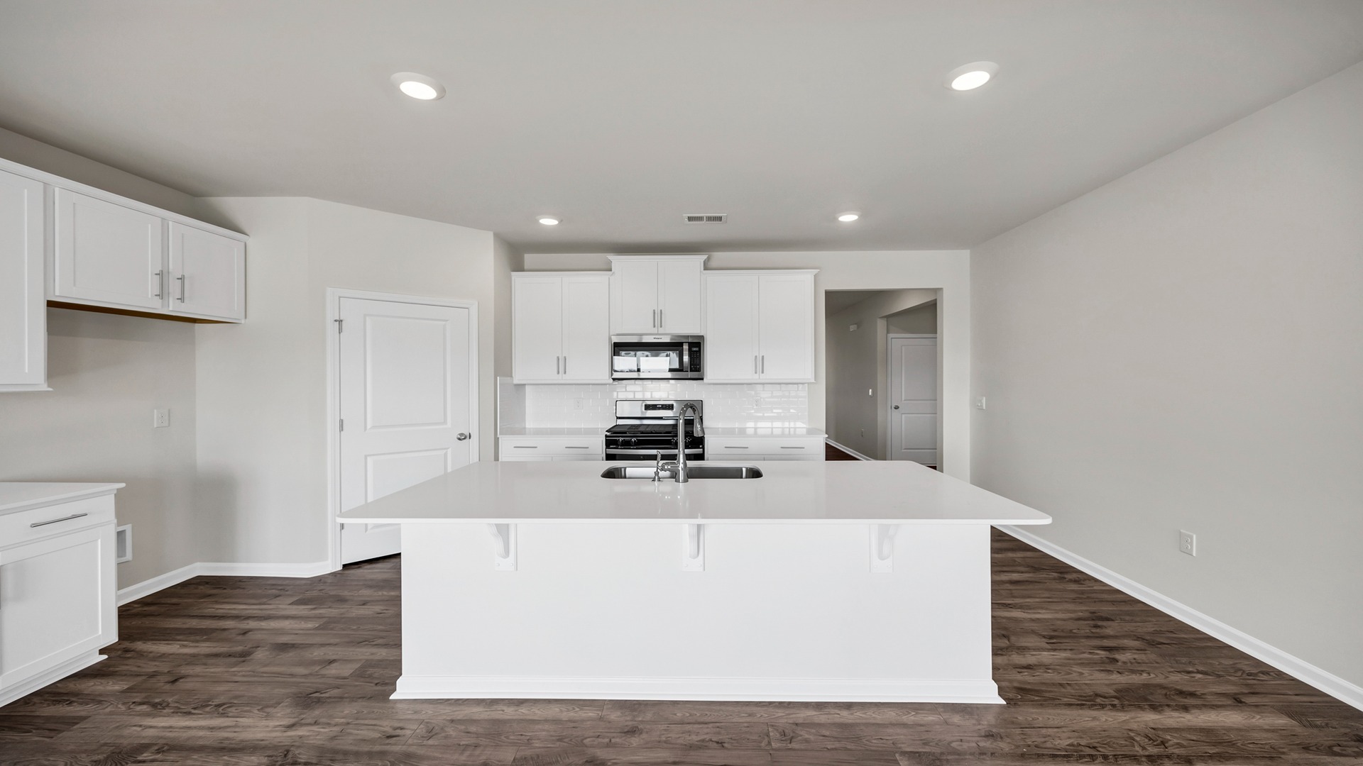 Quartz countertops and tile backsplash in the kitchen