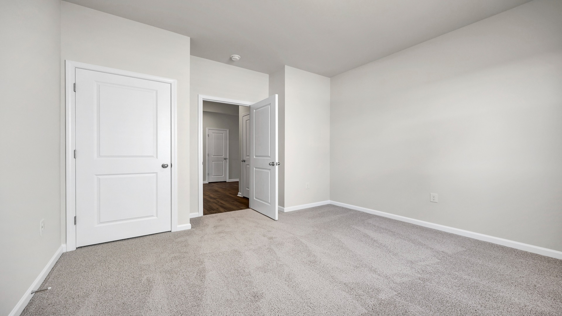 Bedroom 4 with a private closet and neutral-colored paint