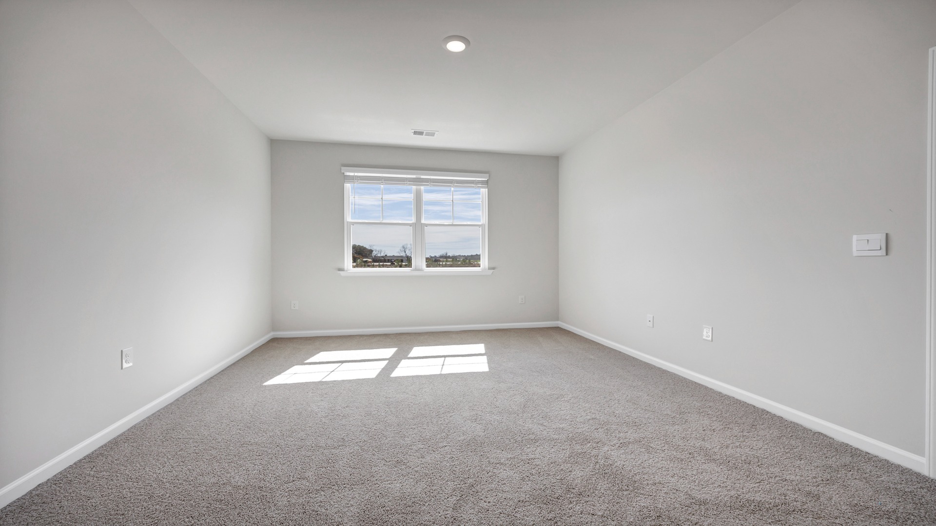 Spacious primary bedroom tucked into the back of ranch-style new construction home in Irmo