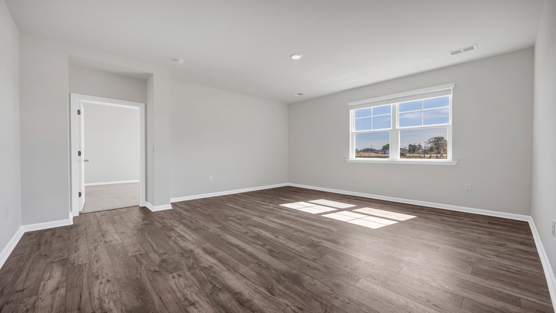 Living area at the back of the home leads into the private primary suite