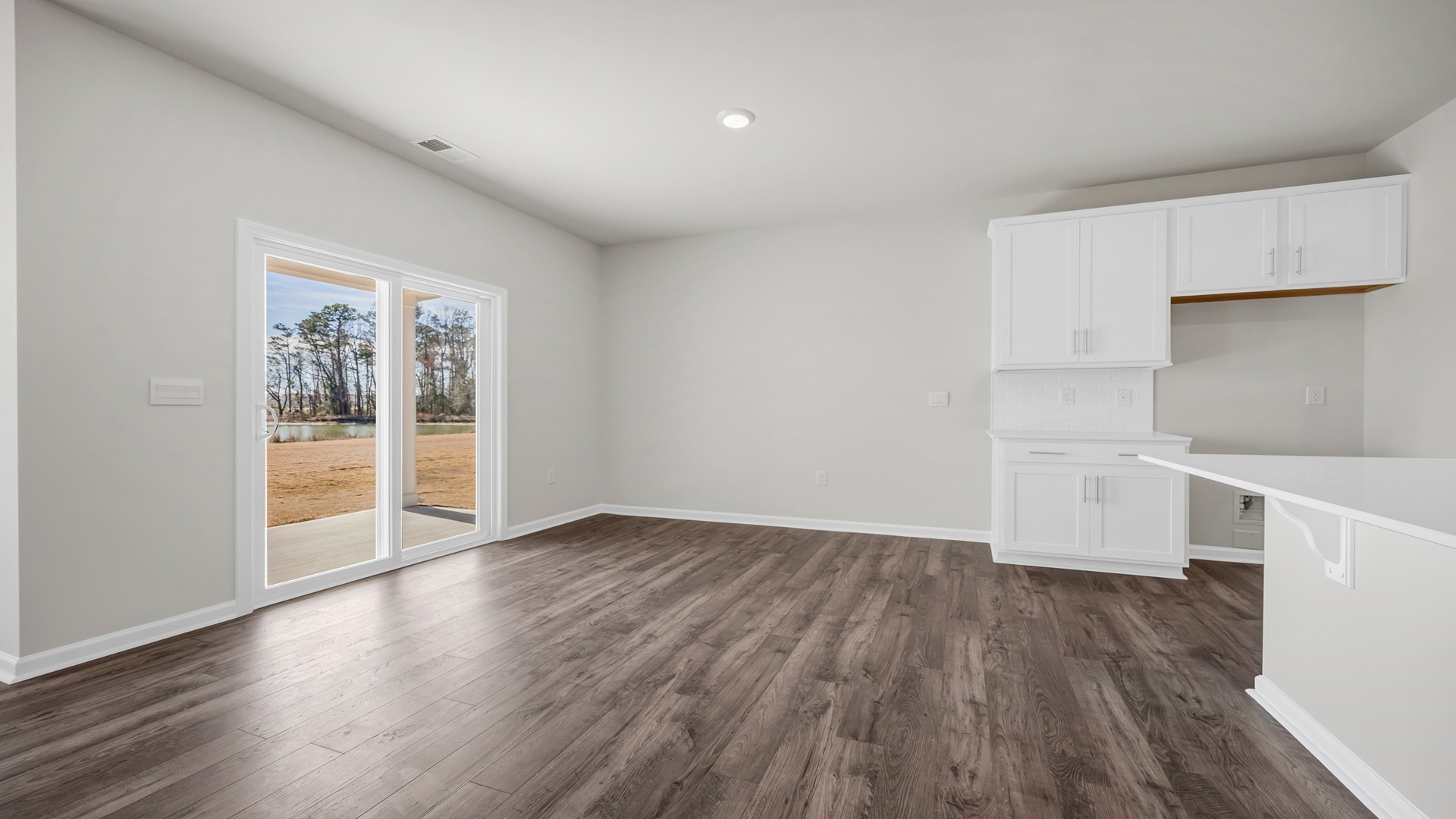 Dining area with RevWood floor and natural light from the back sliding doors