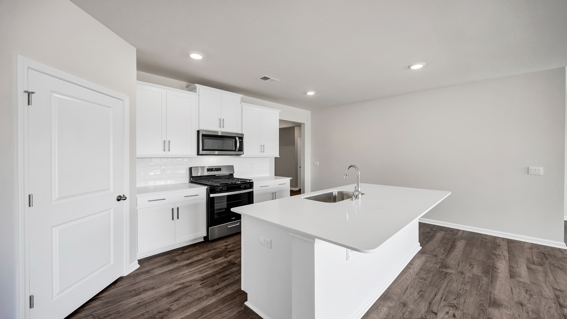 Modern, sleek white countertops in the kitchen space