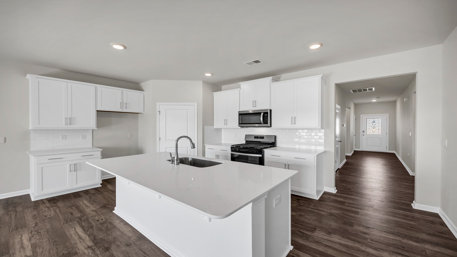 Front foyer leads into the open, modern kitchen space