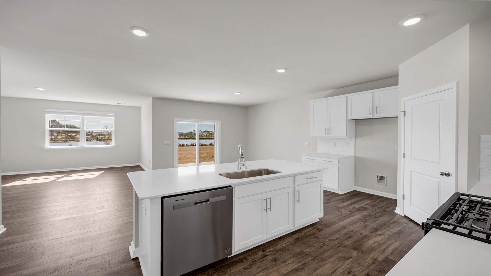 Floating kitchen island overlooks the open concept dining and living areas